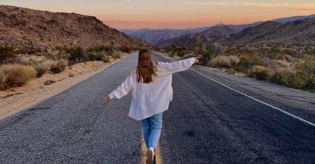 au pair walking down a dessert highway