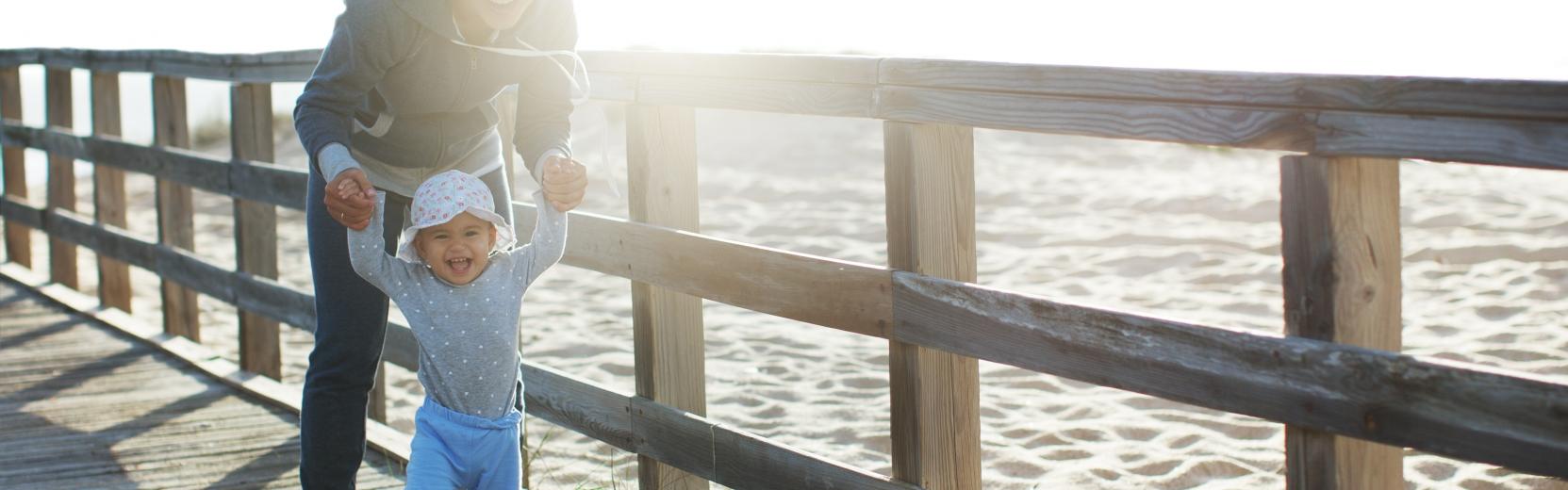 Au pair with child at the sea