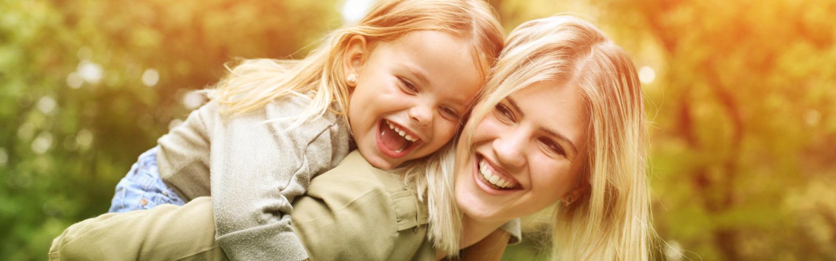 Au pair placement service Au pair with child on her back
