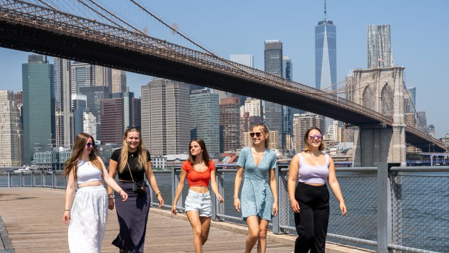 group of five au pairs walking close to Brooklyn Bridge