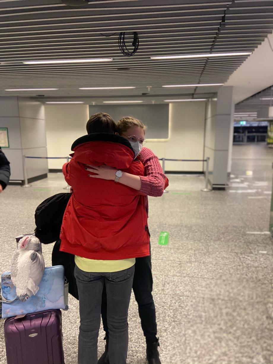 Au pair Laura meeting her family Laura hugging her host family at the airport upon her arrival