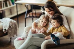 Au pair with kids on armchair