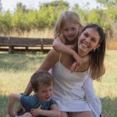 woman with two kids on a meadow